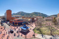 A Digital Luminism watercolor of Pearl Street Mall, Boulder, Colorado rendered in the combined styles of Renoir and Sargent, with the Flatirons rising beneath a brilliant blue sky.